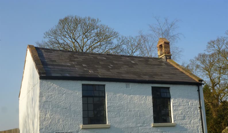 Slate re-roofing and chimney work on a rendered cottage at Brimstage